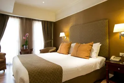 a hotel room with a bed and a telephone at Hera Hotel in Athens