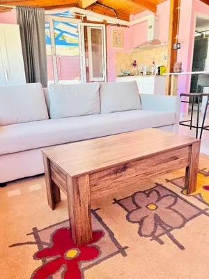 a living room with a couch and a coffee table at sky inn with wonderful Acropolis view in Neos kosmos in Athens