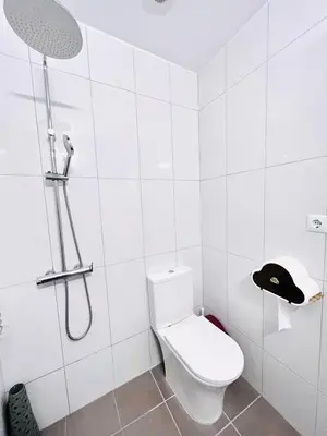 a white bathroom with a shower and a toilet at sky inn with wonderful Acropolis view in Neos kosmos in Athens