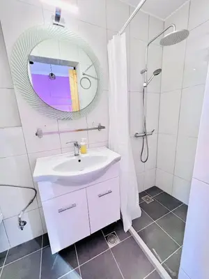 a white bathroom with a sink and a mirror at sky inn with wonderful Acropolis view in Neos kosmos in Athens