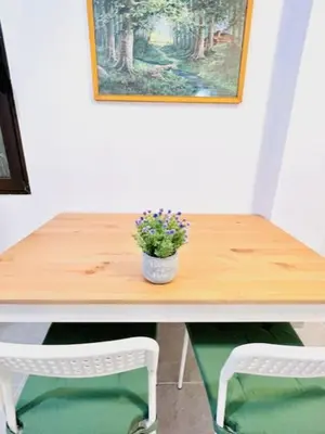 a wooden table with two chairs and a potted plant on it at sky inn with wonderful Acropolis view in Neos kosmos in Athens