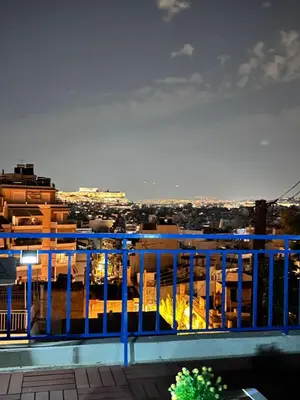 a view of a city from a balcony at sky inn with wonderful Acropolis view in Neos kosmos in Athens