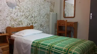 a bedroom with a bed and a table and a mirror at Alma in Athens