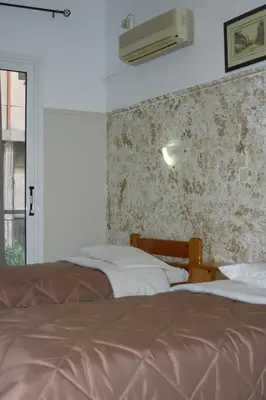 a hotel room with two beds and a window at Alma in Athens
