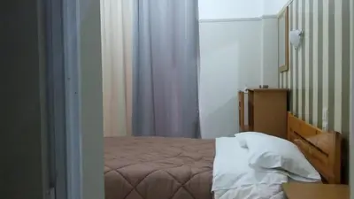 a small bedroom with a bed and a window at Alma in Athens