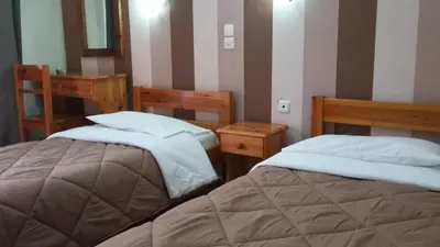 two beds sitting next to each other in a room at Alma in Athens