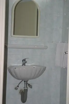 a white sink in a bathroom with a mirror at Alma in Athens
