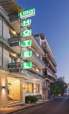 a building with green signs on the side of it at Lilia Hotel in Piraeus