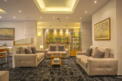 a living room with two couches and a table at Lilia Hotel in Piraeus