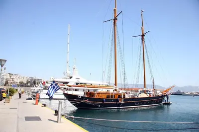 a large boat in the water next to a dock at Lilia Hotel in Piraeus