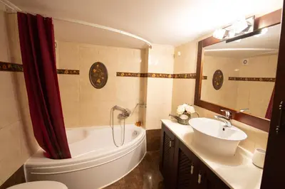 a bathroom with a tub and a toilet and a sink at DIMANTHEO in Athens