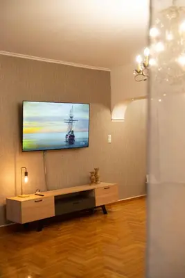 a living room with a tv on a wall at DIMANTHEO in Athens