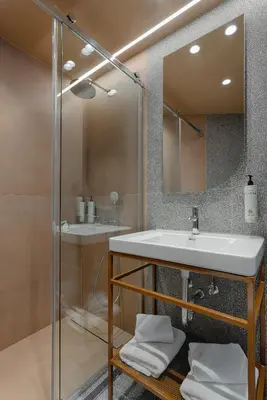 a bathroom with a sink and a shower at Evripides Hotel in Athens