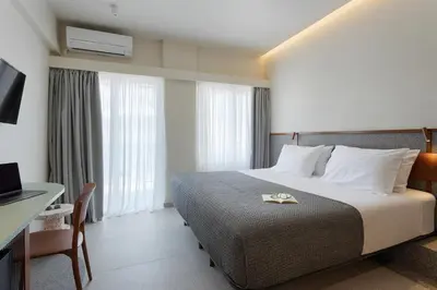 a hotel room with a bed and a desk at Evripides Hotel in Athens