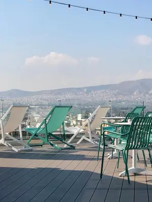 a group of chairs and tables on a roof at Evripides Hotel in Athens