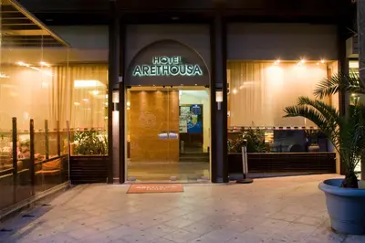 a hotel entrance with a sign on the front of a building at Arethusa Hotel Athens in Athens