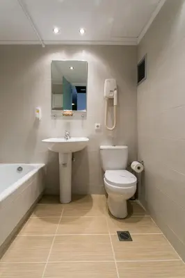 a bathroom with a sink and a toilet and a bath tub at Arethusa Hotel Athens in Athens