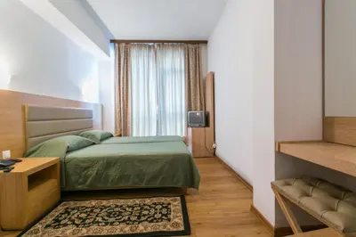 a hotel room with a bed and a television at Arethusa Hotel Athens in Athens