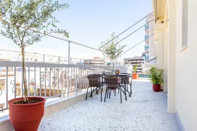 a patio with a table and chairs on a balcony at Lucas apartment 1 in Athens