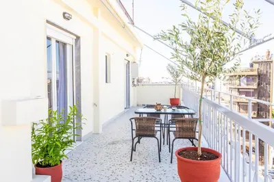 a balcony with a table and chairs and plants at Lucas apartment 1 in Athens
