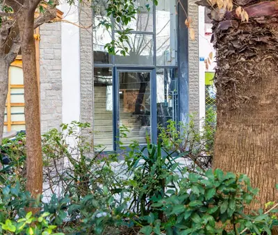 a house with a glass door on the side of it at Lucas apartment 1 in Athens