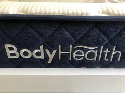 a mattress with the words body health written on it at Lucas apartment 1 in Athens