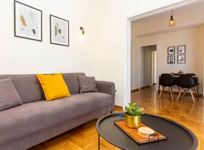 a living room with a couch and a table at Lucas apartment 1 in Athens