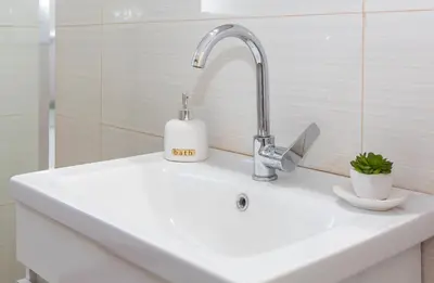 a sink with a faucet and a soap dispenser on it at Lucas apartment 1 in Athens