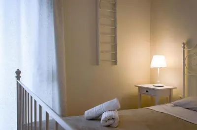 a bedroom with a bed and a lamp and a window at Beautiful 2bd apartment near historic center of Athens in Athens