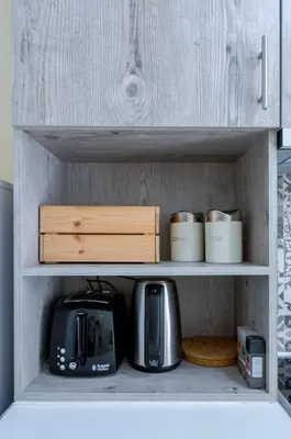 a kitchen shelf with a microwave and coffee pots and pans at Beautiful 2bd apartment near historic center of Athens in Athens