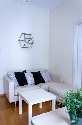 a white living room with a couch and a table at Beautiful 2bd apartment near historic center of Athens in Athens