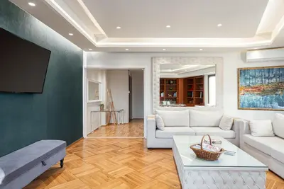 a living room with a couch and a tv at Acropolis Prestige Residence in Athens