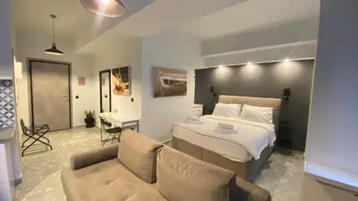a hotel room with a bed and a couch at Monastiraki 112 - 38m2 SuperHost Hub in Athens