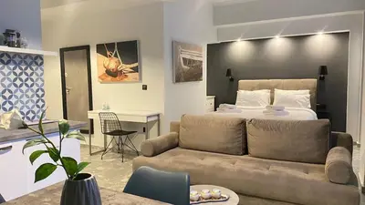 a living room with a bed and a couch at Monastiraki 112 - 38m2 SuperHost Hub in Athens