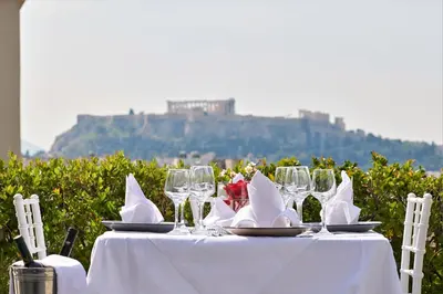 a white table with wine glasses and napkins on it at Crystal City Hotel in Athens