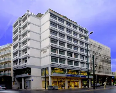 a large white building on a city street at Crystal City Hotel in Athens
