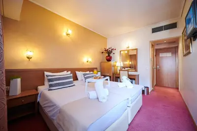a hotel room with two beds and a mirror at Crystal City Hotel in Athens