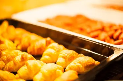 a bunch of donuts in a tray in a buffet at Crystal City Hotel in Athens