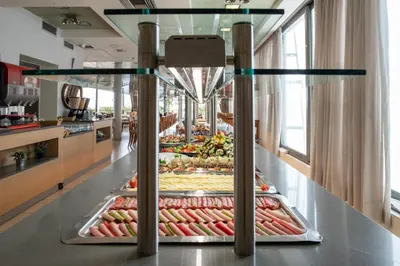 a display case filled with lots of fruits and vegetables at Athens Golden City Hotel in Athens