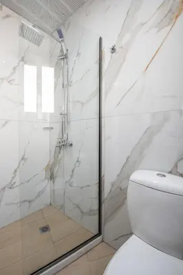 a bathroom with a shower and a toilet at Athens Golden City Hotel in Athens