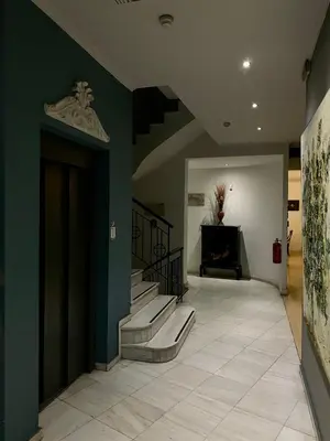 a hallway with stairs and a green wall at Art Hotel Athens in Athens