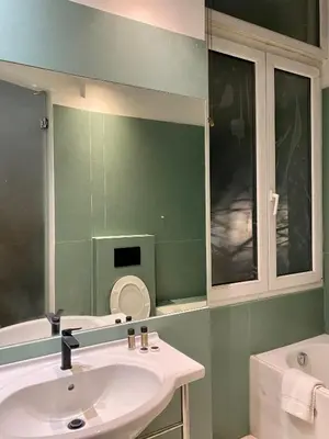 a bathroom with a sink and a mirror at Art Hotel Athens in Athens