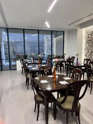 a dining room with tables and chairs and windows at Art Hotel Athens in Athens