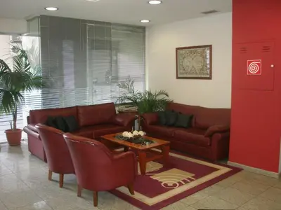 a living room with a couch and a table at Economy Hotel in Athens