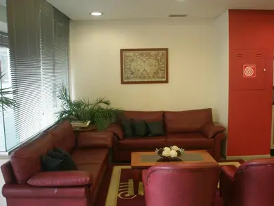 a living room with a couch and a table at Economy Hotel in Athens