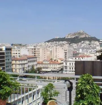 a view of a city with a mountain in the background at Economy Hotel in Athens