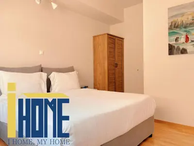 a bedroom with a bed and a wooden cabinet at Skiathou 12 Contemporary Residences in Athens