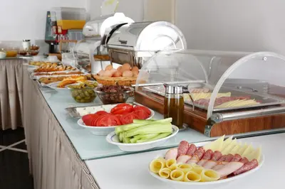 a buffet with many plates of food on a counter at Attalos Hotel in Athens