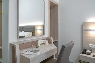 a room with a desk with a mirror and a chair at Attalos Hotel in Athens
