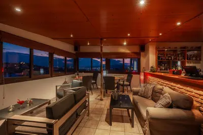 a living room with a couch and a bar at Attalos Hotel in Athens